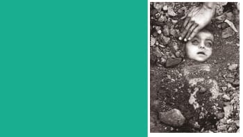 Black and white photograph of an infant being buried in a grave. Only their face is visible under the dirt and rocks. Their eyes are open and clouded. An adult's hand reaches in to touch the child's forehead. 